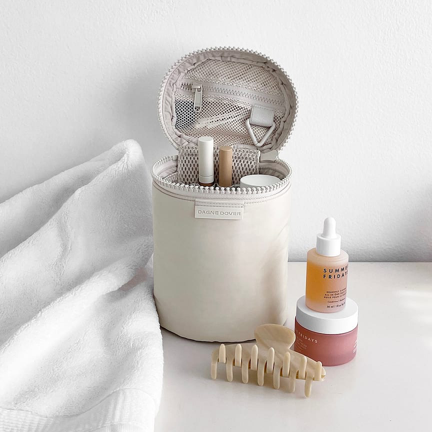 Structured toiletry organizer with upright compartments for travel-sized beauty and skincare products